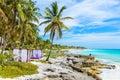 Beach beds under the palm trees on paradise beach at tropical Resort. Riviera Maya - Caribbean coast at Tulum in Quintana Roo, Royalty Free Stock Photo