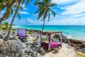 Beach beds under the palm trees on paradise beach at tropical Resort. Riviera Maya - Caribbean coast at Tulum in Quintana Roo, Royalty Free Stock Photo