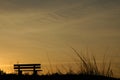 Beach bench at sunset