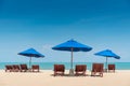 Beach bench under the umbrella on tropical island beach Royalty Free Stock Photo