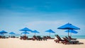 Beach bench under the umbrella on tropical island beach Royalty Free Stock Photo