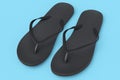 Beach black flip-flops or sandals isolated on blue background.