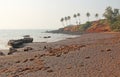 Beach with black sand and palm trees. Dark brown volcanic sand a Royalty Free Stock Photo