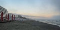 Beach of Black Sea from Mamaia, Romania with sunbeds and umbrellas, foggy day. Royalty Free Stock Photo