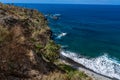 Beach with black volcanic sand, green palm trees on the slope, dangerous waves, Atlantic Ocean, Castro Beach