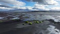 Beach with black volcanic sand in Iceland, Epic aerial view, Green grass grow in black sand, Unearthly landscape, Ocean