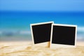 Beach with blank instant photos in front of summer sea background Royalty Free Stock Photo