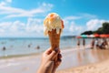 Beach bliss Hand holding ice cream with a sea background