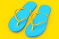 Beach blue flip-flops or sandals isolated on yellow background.