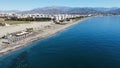 Beach and blue sea with the city buildings and mountains in the background. Torre del Mar, Spain.