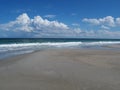 A beach with rolling clouds