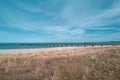 A beach and the blue water of the Baltic Sea and the sky is blue