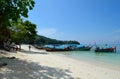 Beach with boats at the coast in Thailand