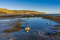 Beach at Boggle Hole and view of Robin Hood`s Bay Royalty Free Stock Photo