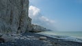 Beach of the Bois de Cise, with cliffs and stones on the shoreline against the blue sky Royalty Free Stock Photo