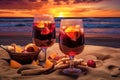 beach bonfire scene with sangria-filled glasses and sunset Royalty Free Stock Photo