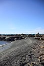 Beach and breakwater with the sea stretching to the horizon on a sunny day in winter