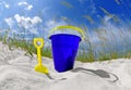 Beach bucket on sand dune Royalty Free Stock Photo