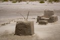 Beach buggy wheelbarrow, sandals, and sand sculpture tools, Matarangi Beach, New Zealand Royalty Free Stock Photo