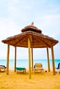 Beach bungalo with beds it's shade Royalty Free Stock Photo