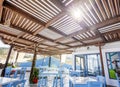 Beach cafe and restaurant with blue and white tables and chairs Royalty Free Stock Photo