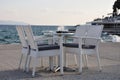 Beach cafe with sea view at sunset, empty table, four chairs, vacant for guests. Royalty Free Stock Photo