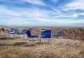 Beach cafe terrace, UK, deserted with no customers. Empty chairs.