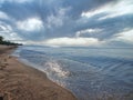 Beach on calm Baltic sea under dramatic cloudy sky Royalty Free Stock Photo