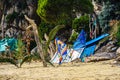 beach campsite with colorful towels, tents and sarongs