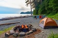 a beach campsite with tents and a fire pit