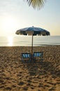 Beach canvas beds with blue and white umbrella Royalty Free Stock Photo