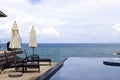 Beach chair in outdoor with swimming pool overlooking view tropical sea Royalty Free Stock Photo