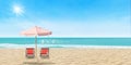 Beach chair and umbrella on sand beach with beautiful seascape view of sea and blue sky in the background.