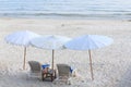 Beach chair and white umbrella parosol. Royalty Free Stock Photo