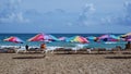 Beach chairls and with colorful umbrellas next to the beach