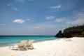 Beach chairs and an azure blue sea