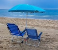 Beach chairs with blue umbrella and beautiful beach on a sunny day. Benidorm, Spain Royalty Free Stock Photo