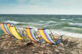 Beach chairs facing a windy sea