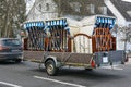 Beach chairs or German Strandkorb on a car trailer are driven to the coast for vacation at the sea when the season starts, Royalty Free Stock Photo