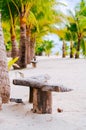 Beach chairs, palm trees and beautiful white sand beach in tropical island Royalty Free Stock Photo