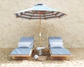 Beach chairs on the sand with white and blue umbrella on beige stone wall and decor. 3d rendering. High quality 3d Royalty Free Stock Photo