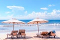 Beach with chairs. Sunbeds and umbrella at Bali coast. Luxury beach background. Royalty Free Stock Photo