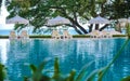 beach chairs at a swimming pool with umbrellas Royalty Free Stock Photo