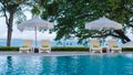 beach chairs at a swimming pool with umbrellas Royalty Free Stock Photo