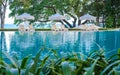 beach chairs at a swimming pool with umbrellas Royalty Free Stock Photo