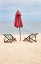 Beach chairs and an umbrella on an empty beach