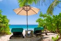 Beach chairs and umbrella in paradise beach.