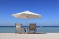 Beach chairs with an umbrella and a small table Royalty Free Stock Photo