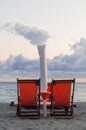 Beach chairs and umbrella at sunset on an italian beach in late summer Royalty Free Stock Photo