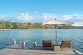 Beach chairs and umbrella on wooden desk against blue sky in Phuket,Thailand. Royalty Free Stock Photo